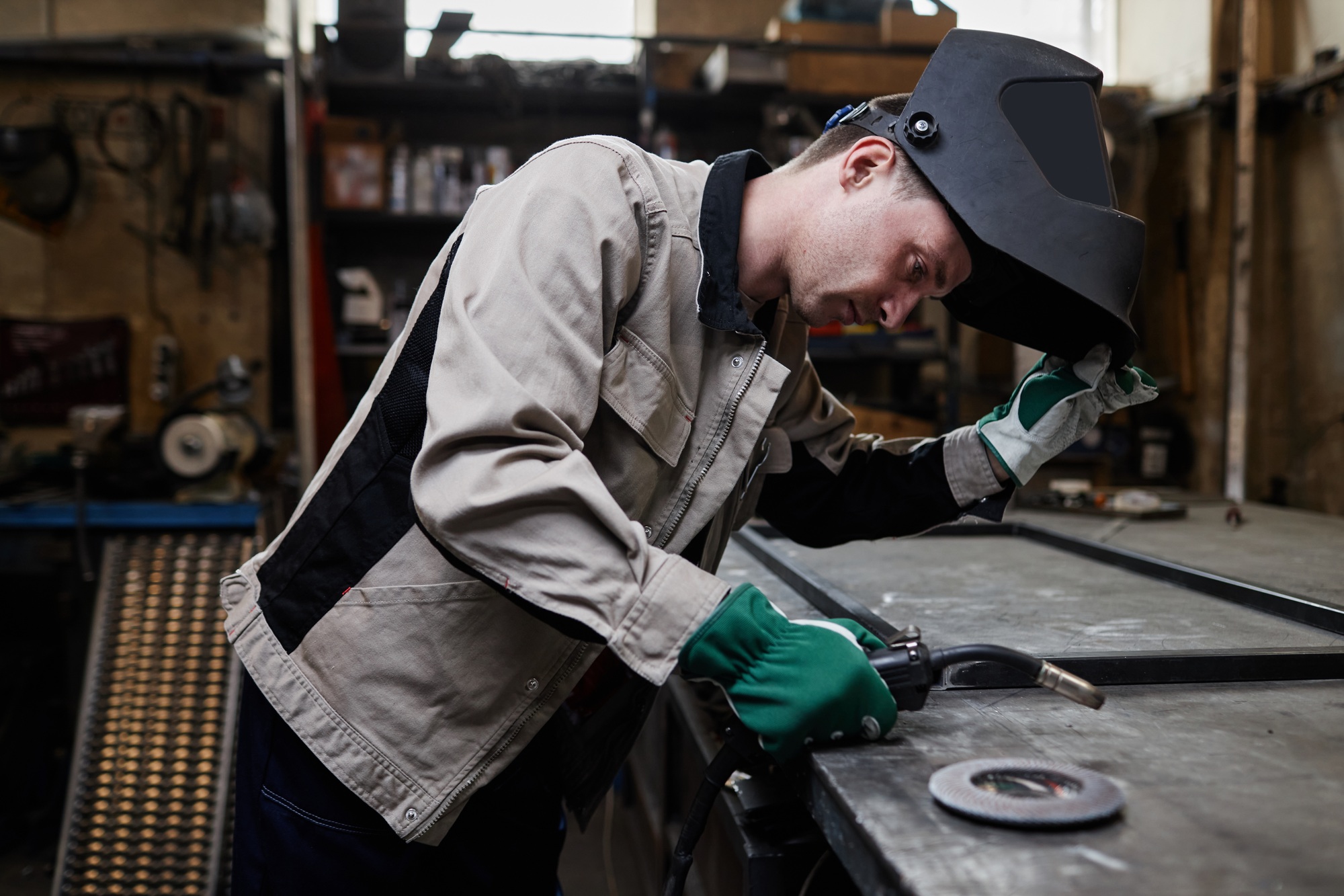 Portrait Of Smiling Welder In Workshop